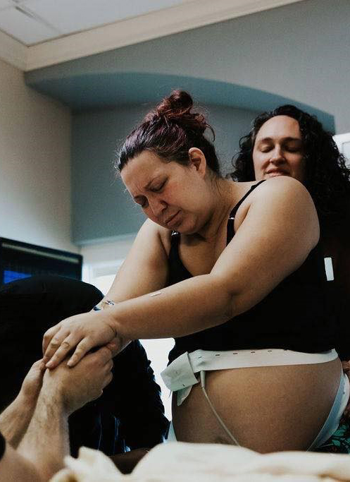 A mother in labor being supported by a birth doula