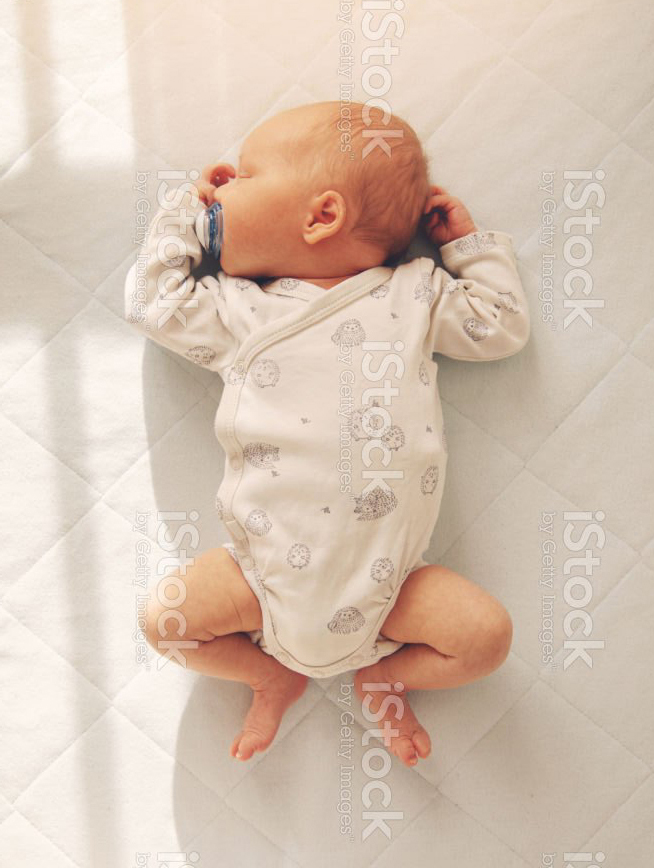 A baby sleeping soundly in a crib